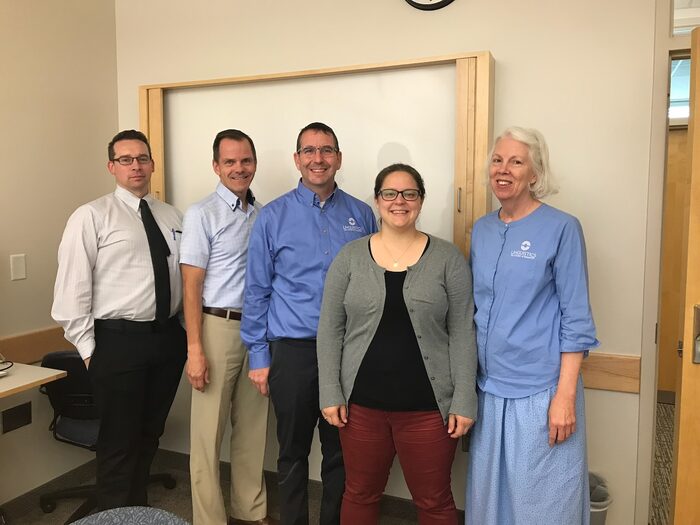 Troy Cox with AnnMarie Saunders and committee members at her project defense