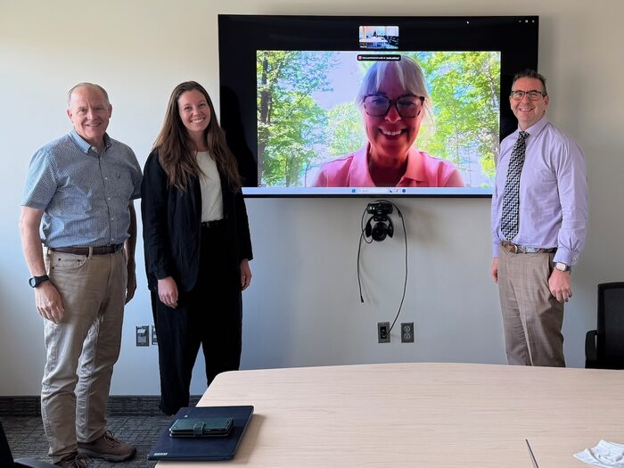 Troy Cox with Ashlee Farnsworth and committee members, joining by video, at her portfolio defense