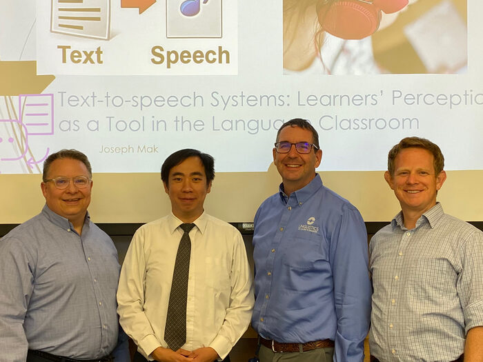 Joseph Mak presenting his thesis research, with Troy Cox and committee members